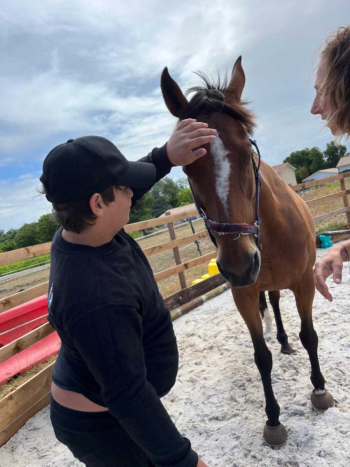 Sortie éducative en extérieur — jeune caressant un cheval, activité sensorielle Bordeaux Métropole